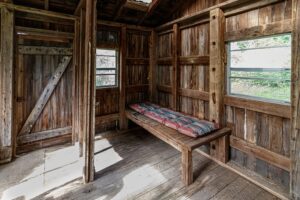 Bench with faded red and blue cushions in Granary.